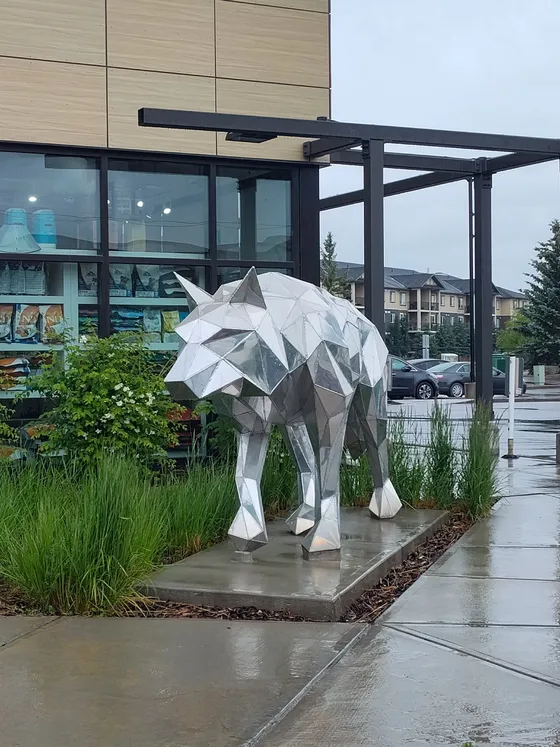 A silver wolf sculpture outside shops in the Legacy Gate Village plaza in Legacy, Calgary.