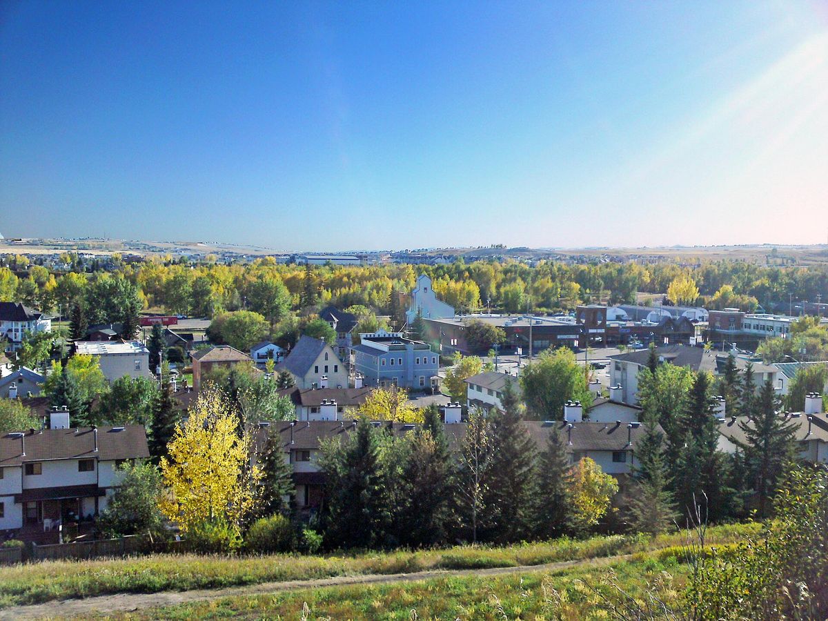 Houses and autumn trees at Okotoks, Alberta, seen from a hillside in 2009.